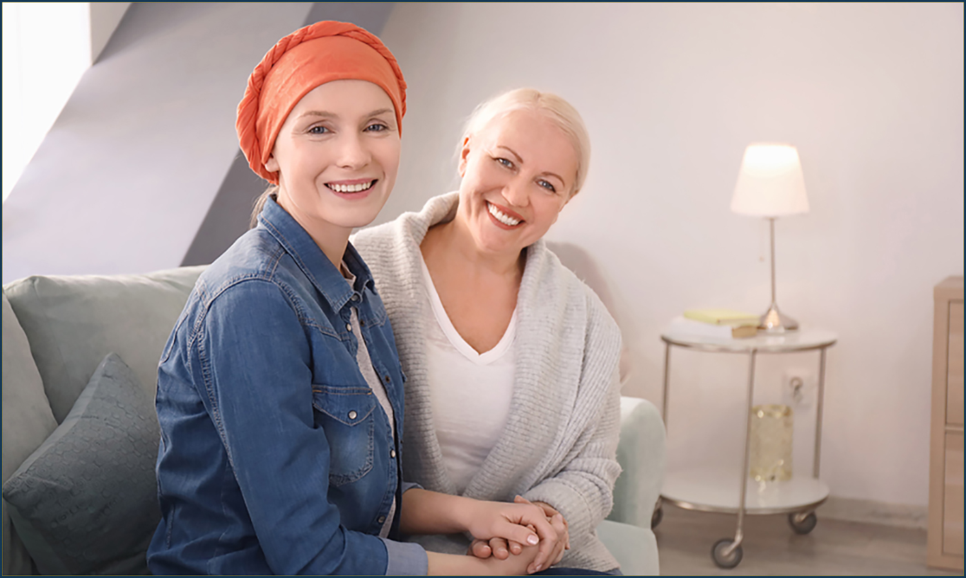 Mature woman visiting her daughter with cancer indoors