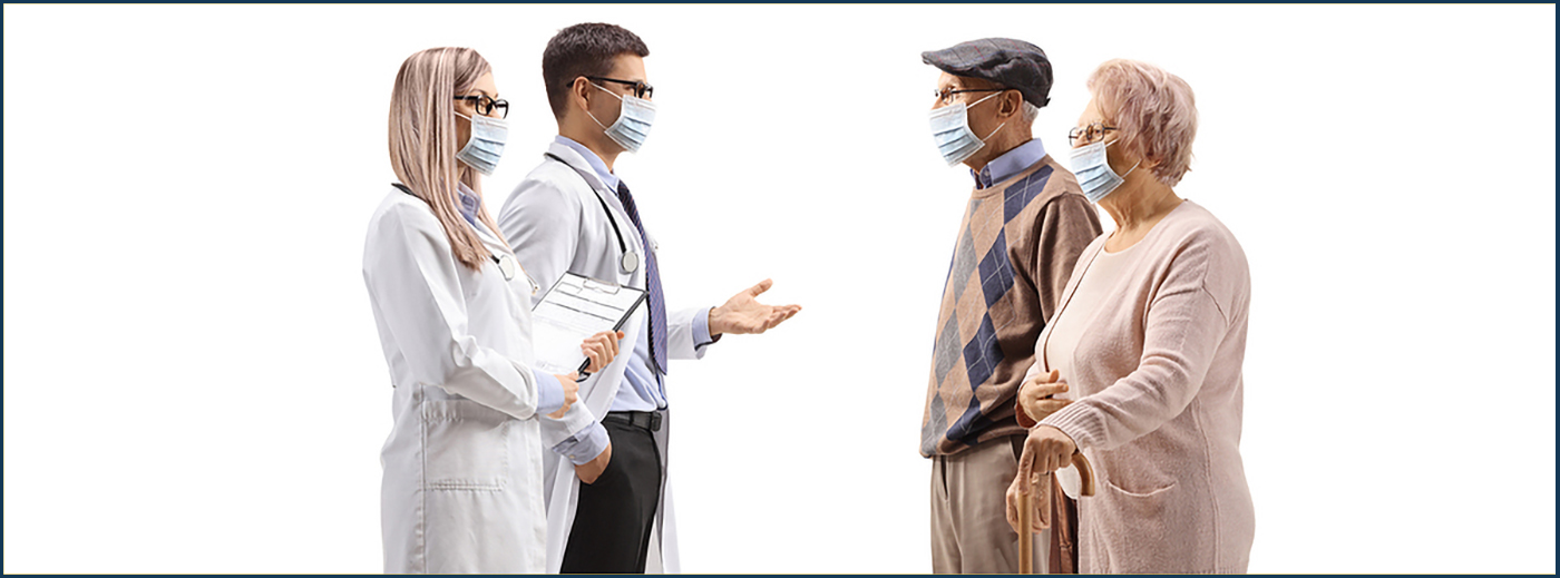 Full length profile shot of a male and female doctor with medical masks talking to elderly patients isolated on white background